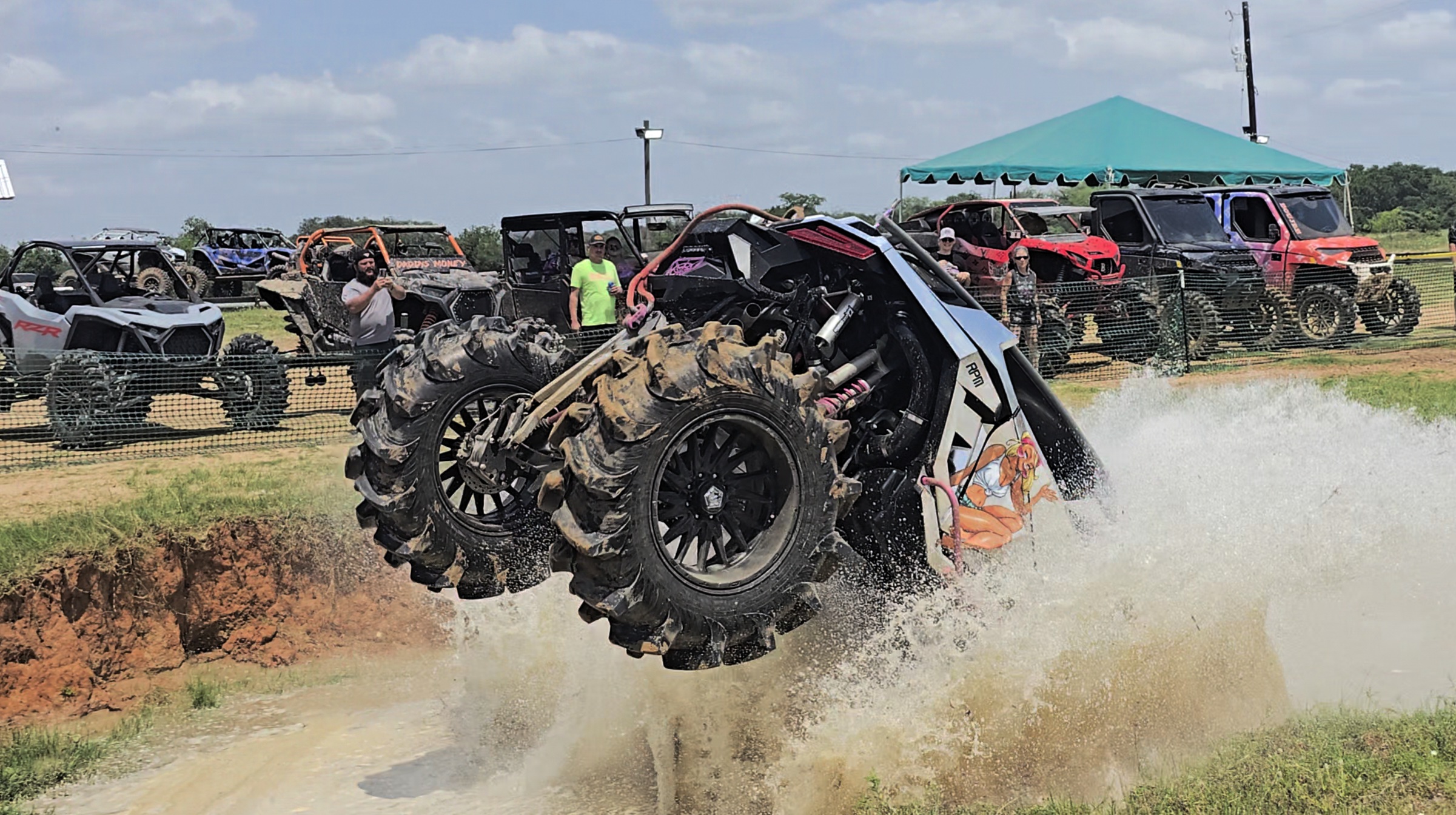 SxS vehicles lined up at an off road community gathering